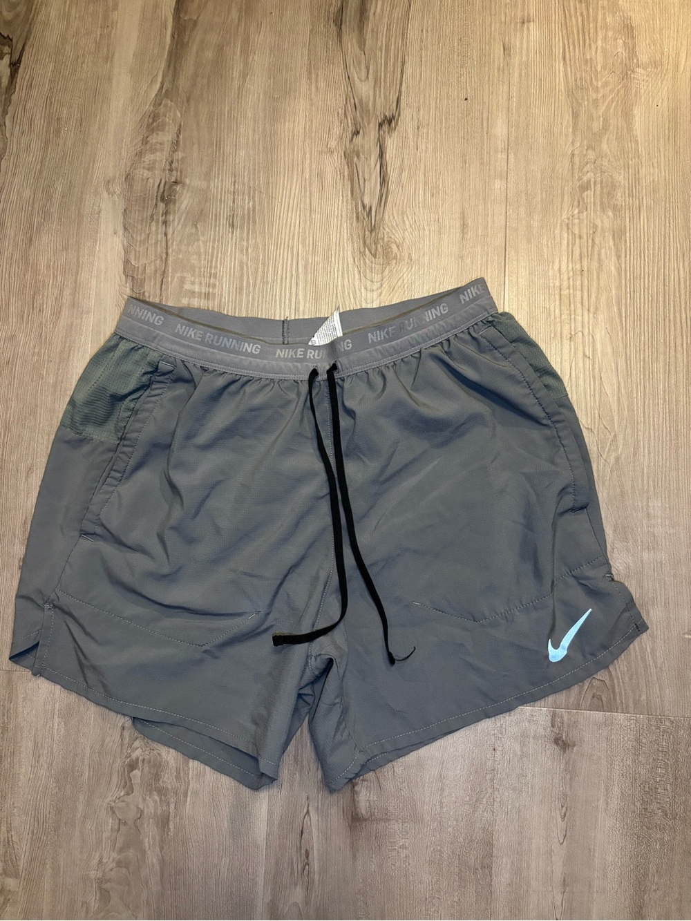 Nike Men’s Gray Athletic Shorts with Light Blue Swoosh